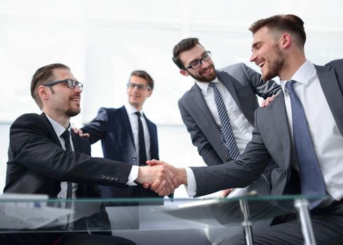 confident handshake business partners at the Desk.concept of partnership