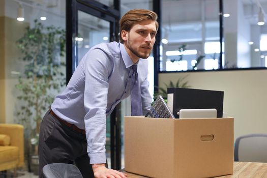 Dismissed worker going from the office with his office supplies