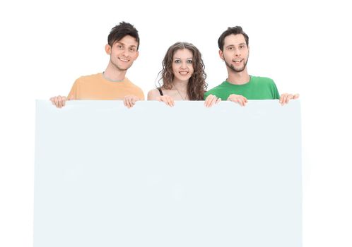 group of young people holding a large blank poster .isolated on a white background.