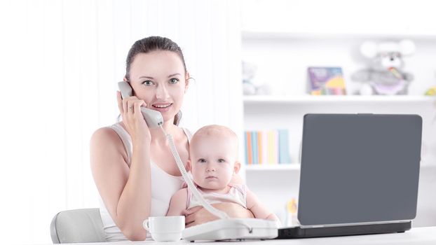 modern young mother talking on the phone. the concept of freelancing