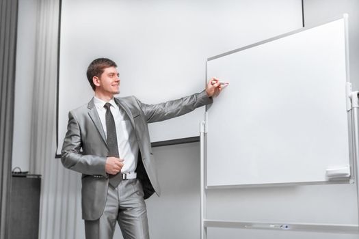 confident businessman standing on stage in the conference hall . business and education