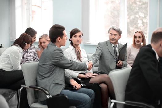 handshake colleagues in the conference room before the meeting.the concept of teamwork