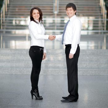 welcome handshake of young business partners on the background of the office.photo with copy space