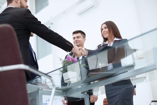 businesswoman handshake with business partner in modern office.