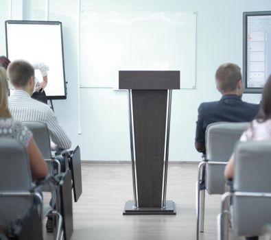 adult businessman makes a report for employees at a meeting in the office.