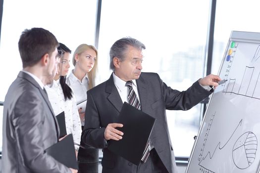 businessman pointing with pen on the flipchart. business presentation