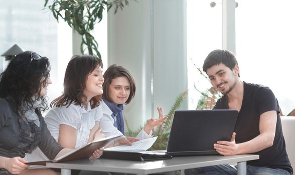 handshake colleagues sitting at the workplace. office life