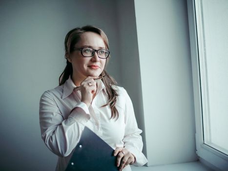 attentive business woman looking out the window of the office.photo with copy space