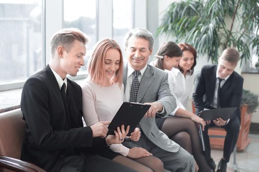 young businessman showing a document to his colleagues.office weekdays