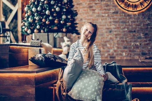 little girl in the living room on Christmas eve . holiday concept