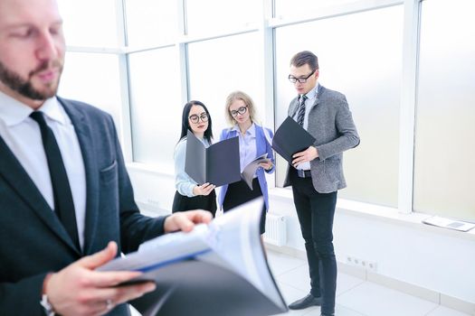 businessman and his colleagues studying business documents standing in the office. business concept