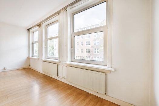 Large bright room with huge windows and street views