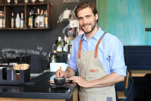 Small business owner working at his cafe