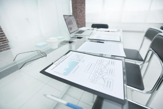 financial chart about the report on the glass table in the office.