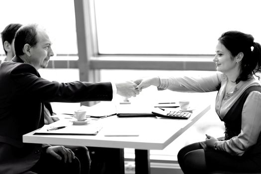 handshake of a businessman and business woman over a Desk.concept of partnership