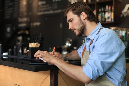 Small business owner working at his cafe
