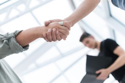 close up. business handshake over blurry background . photo with a copy of the space.