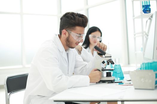 scientists biologists sitting at the laboratory table. science and health