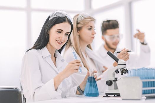 group of young scientists conduct research in the laboratory . science and health