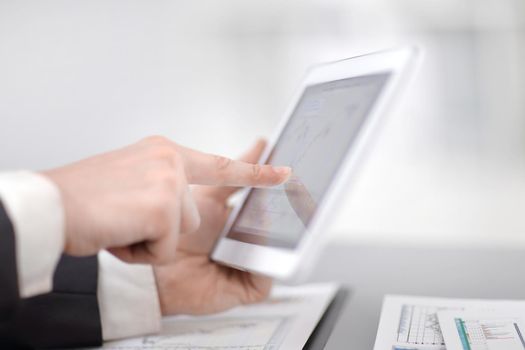 close up.businessman using digital tablet in the workplace.