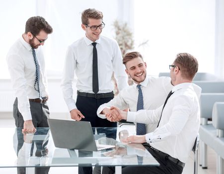 happy employees shaking hands .success concept