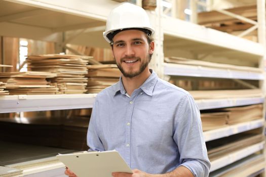 portrait of a smiling young warehouse worker working in a cash and carry wholesale store