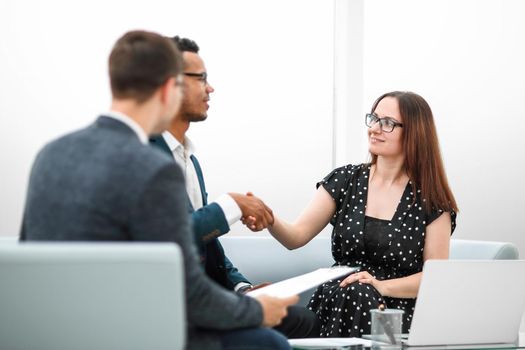 welcoming handshake of a businessman and businesswoman . photo with copy space