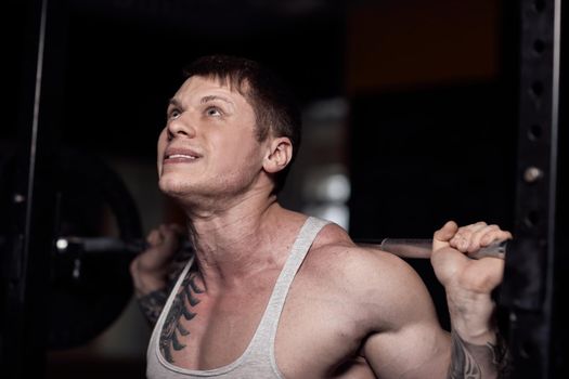 closeup. confident bodybuilder working with a barbell.