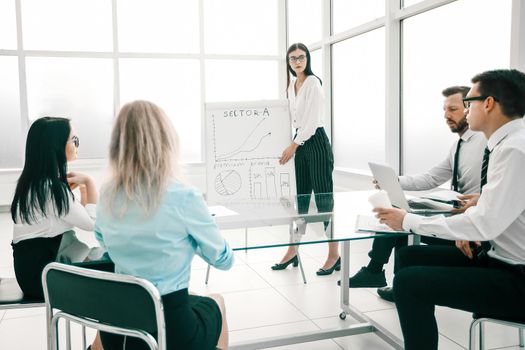 businesswoman discusses with the business team a new business strategy. the concept of a startup
