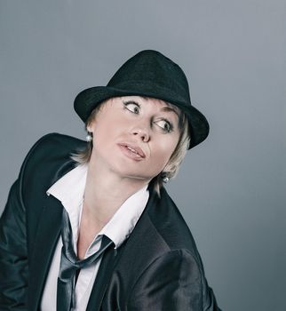 glamorous woman in a pantsuit .isolated on gray background.photo with copy space