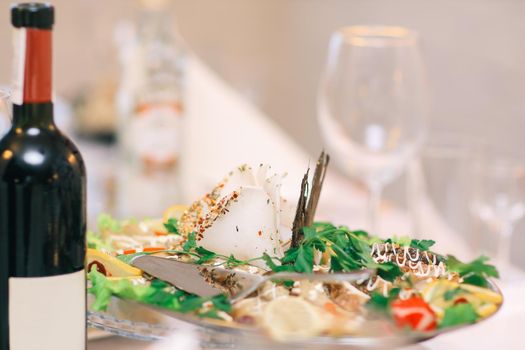 close up.a bottle of wine and a snack on the festive table.