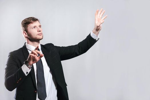 young businessman stretching his hands to virtual poster.