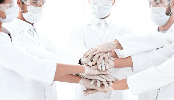 Close-up Photo Of Doctors Stacking Hand With Coworkers.concept of teamwork