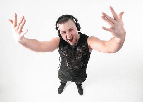view from the top.cool male rapper in headphones watching the camera.isolated on white.