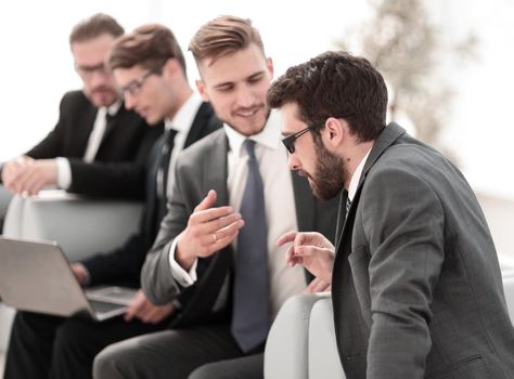 business colleagues talk sitting in the office lobby.photo with copy space