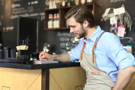 Small business owner working at his cafe