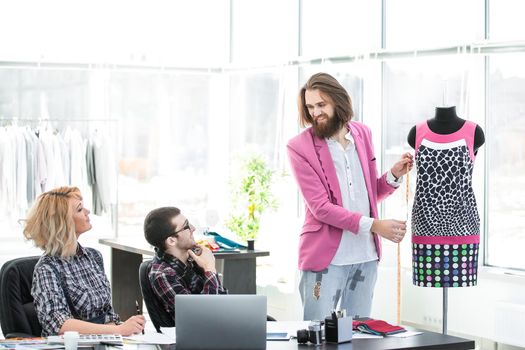 Group of business people brainstorming in a fashion clothing company.