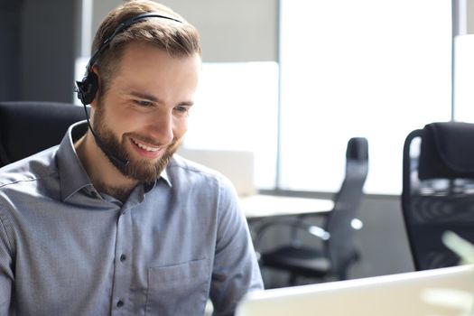 Smiling friendly handsome young male call centre operator