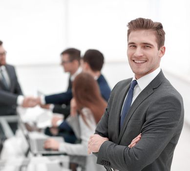 young businessman on blurred office background.