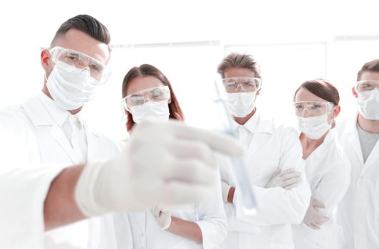 background image is a group of medical workers working with liquids in laboratory .photo with copy space