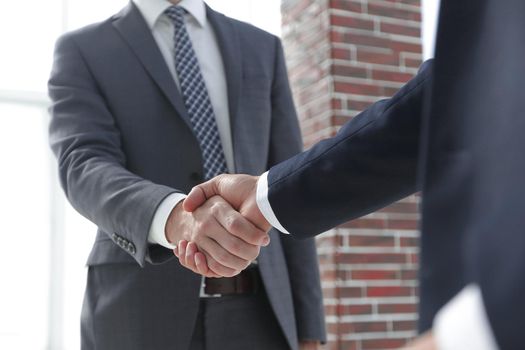 business leader shaking hands with partner.vertical photo