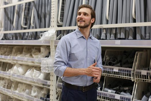 portrait of a smiling young warehouse worker working in a cash and carry wholesale store