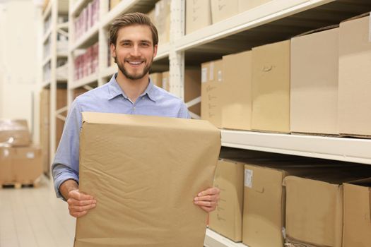 Portrait of a smiling warehouse keeper at work