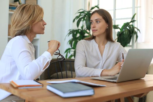 Beautiful businesswoman work together sitting on the table in office