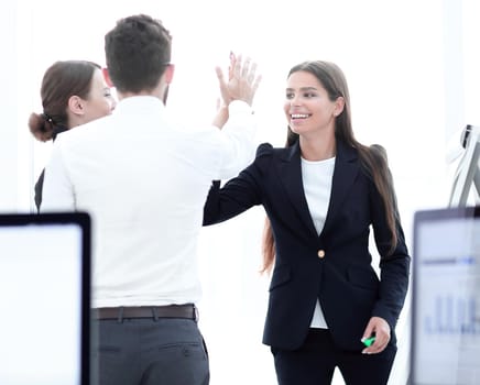 employees giving each other high five.the concept of teamwork