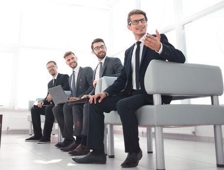 group of young businessmen sitting in the lobby of the business center.photo with copy space