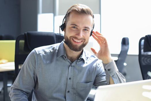 Smiling friendly handsome young male call centre operator