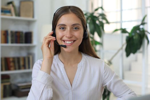 Female customer support operator with headset and smiling