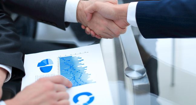 handshake business colleagues in office