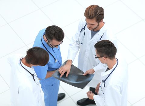 view from the top. a group of doctors discussing an x-ray.isolated on white.photo with copy space